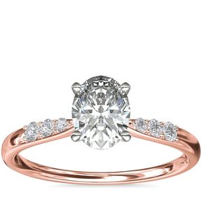 A rose gold engagement ring with an oval 1-carat diamond.